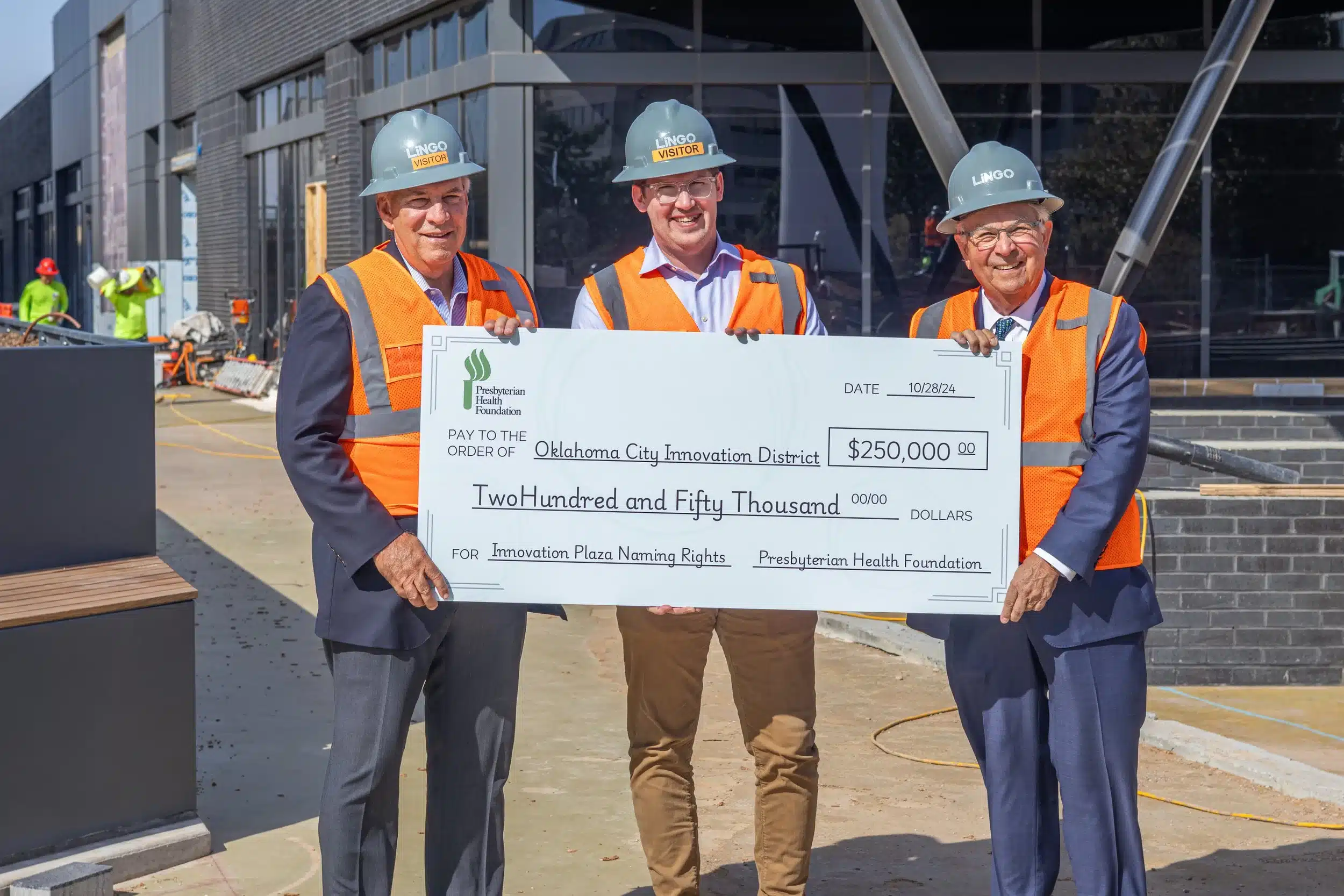 Rick McCune, Jeff Seymour, and Tom Gray present a $250,000 Presbyterian Health Foundation check for Innovation Hall plaza naming rights.