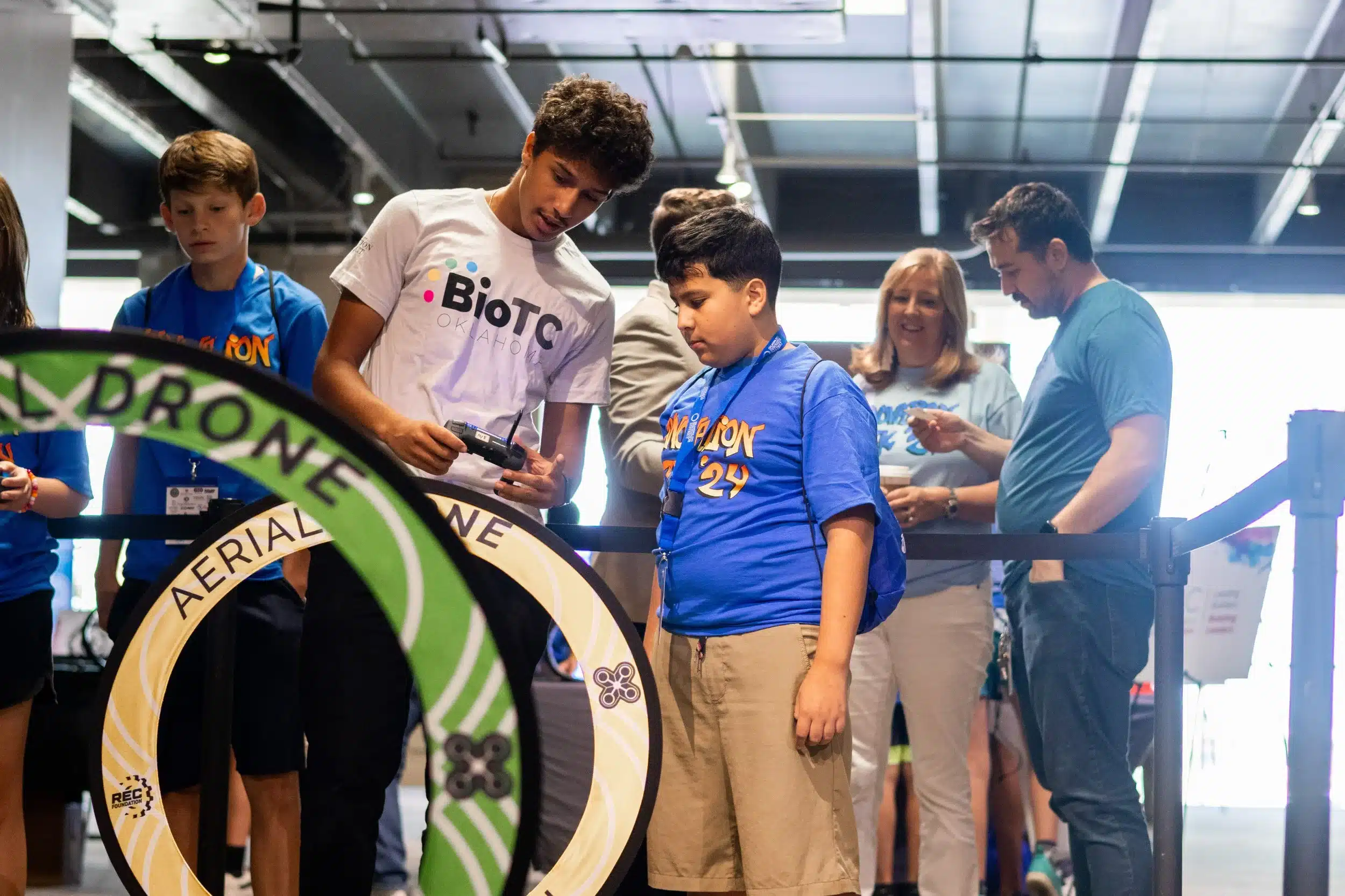 An OKCPS student learns to fly a drone through an obstacle course with Dove Science Academy's Aerial Drone Team.