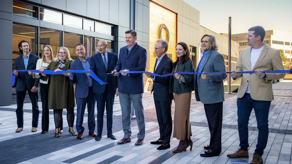 Community leaders cut a blue ribbon outside Innovation Hall and The Tower at Convergence.