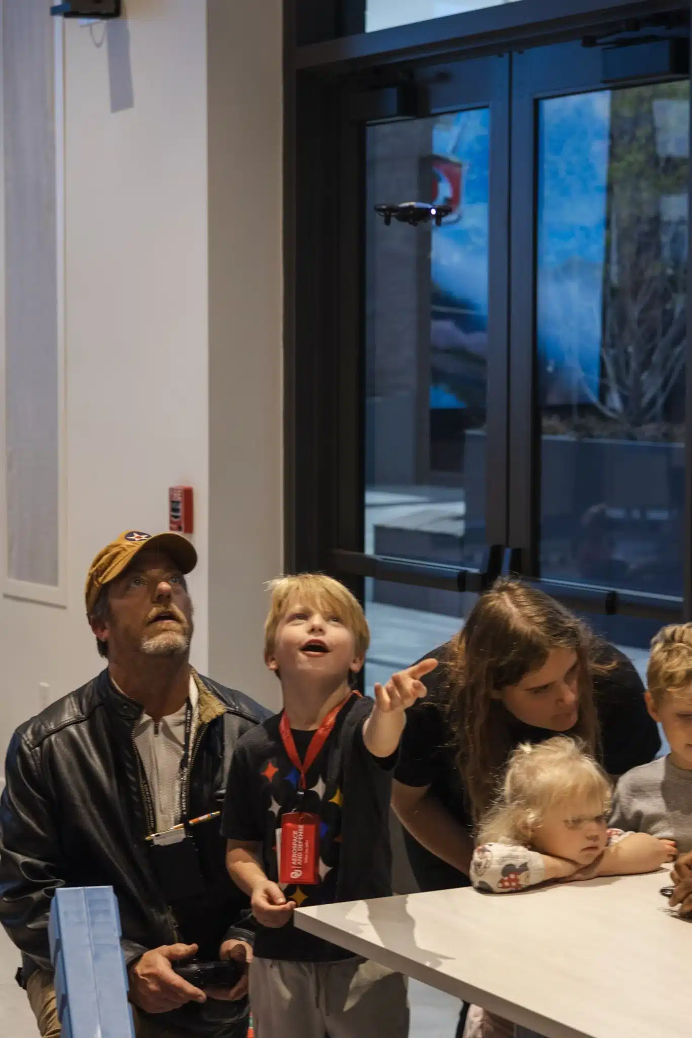 A family watches a small drone fly during Community Night at Innovation Hall.