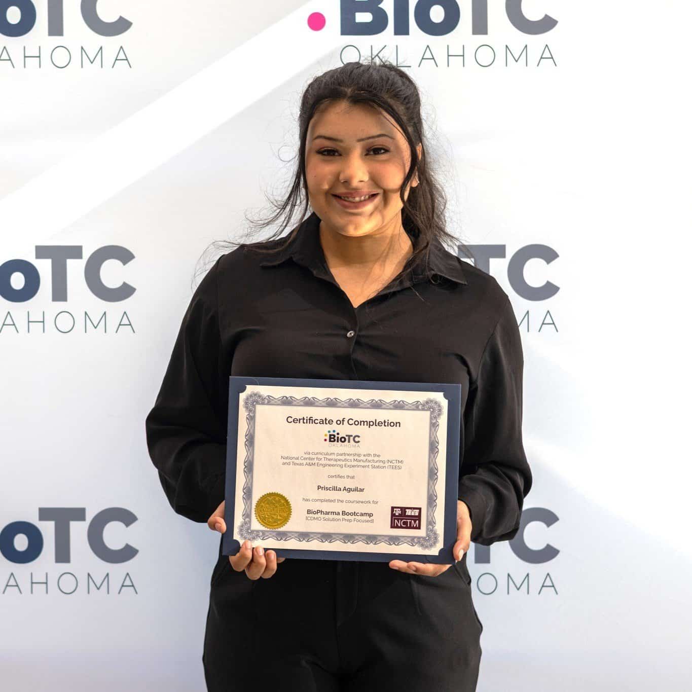 BioTC graduate Priscilla Aguilar holds her certificate of completion.