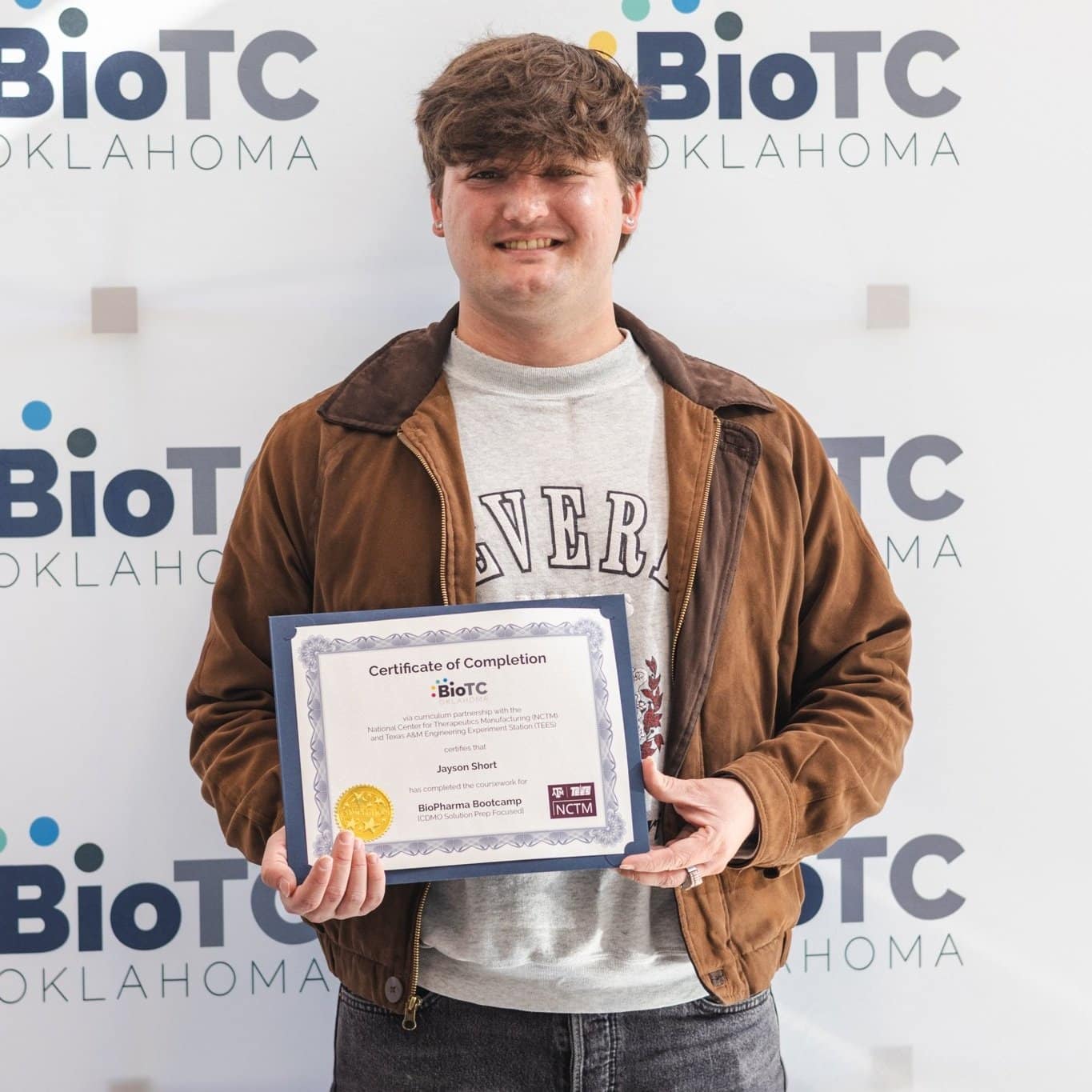 BioTC graduate Jayson Short holds his certificate of completion.
