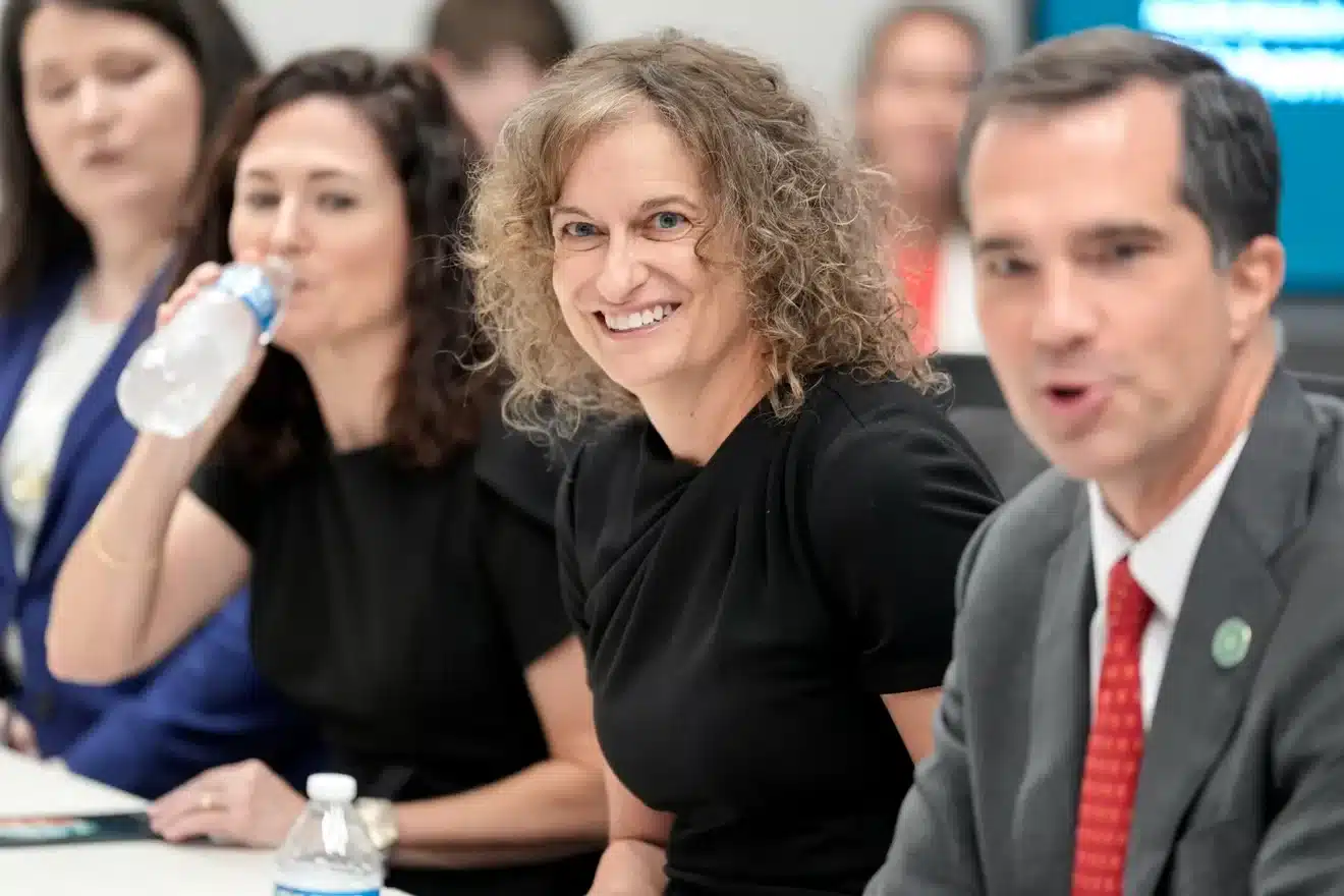 Participants listen and speak at a biotechnology and biomanufacturing roundtable.