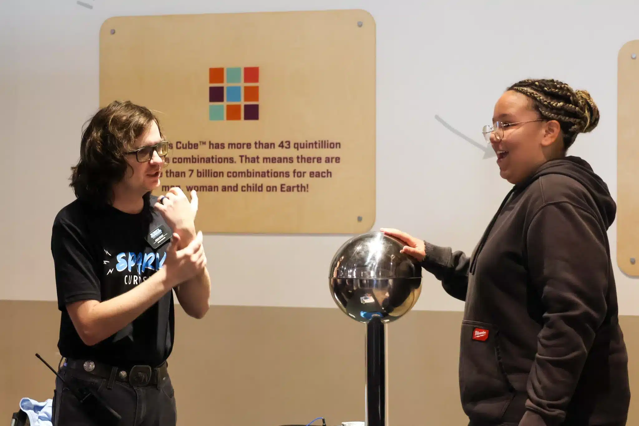 Two students explore a static electricity demonstration with a metal sphere during Innovation Week.