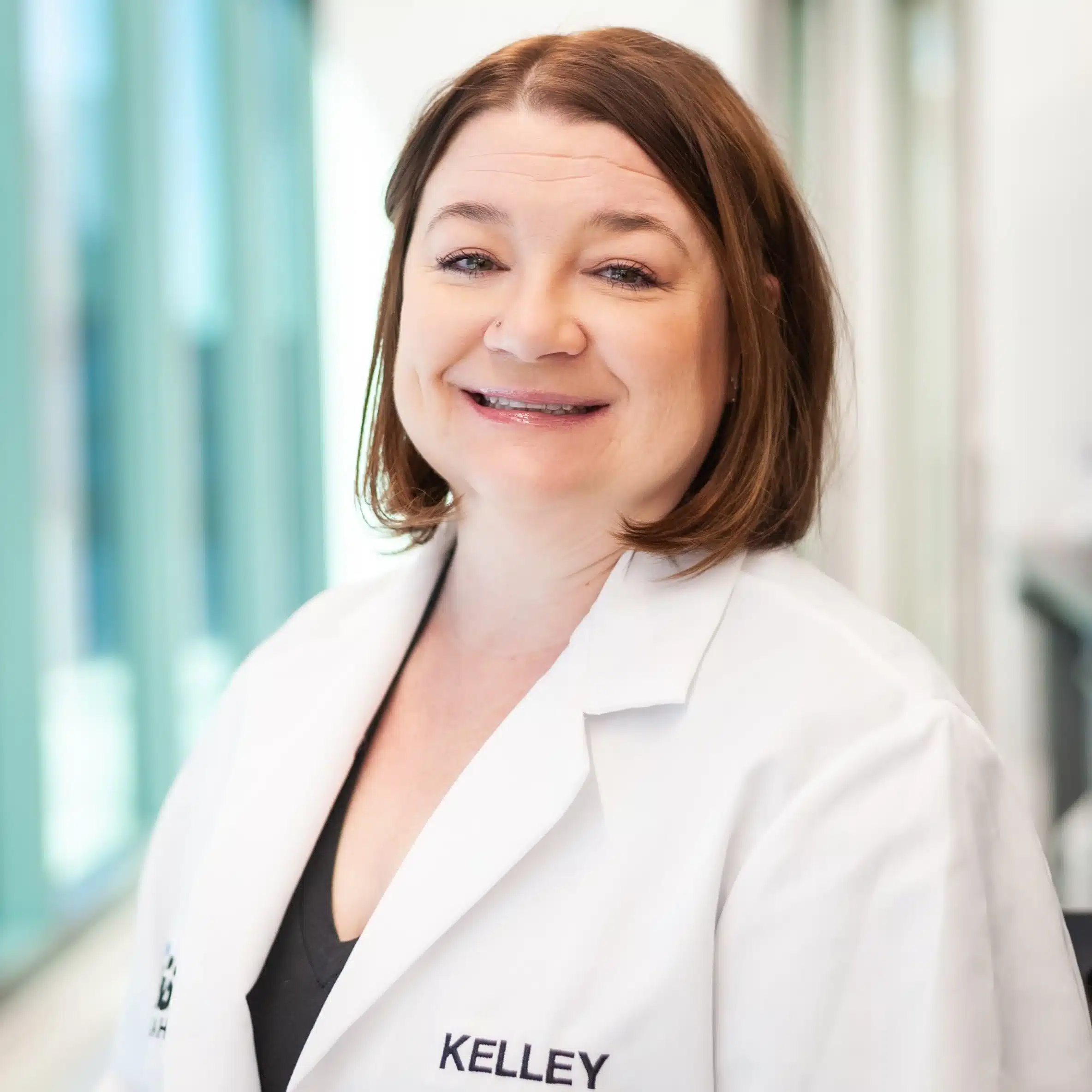 Dr. Kelley Dowd wearing a white lab coat at BioTC.