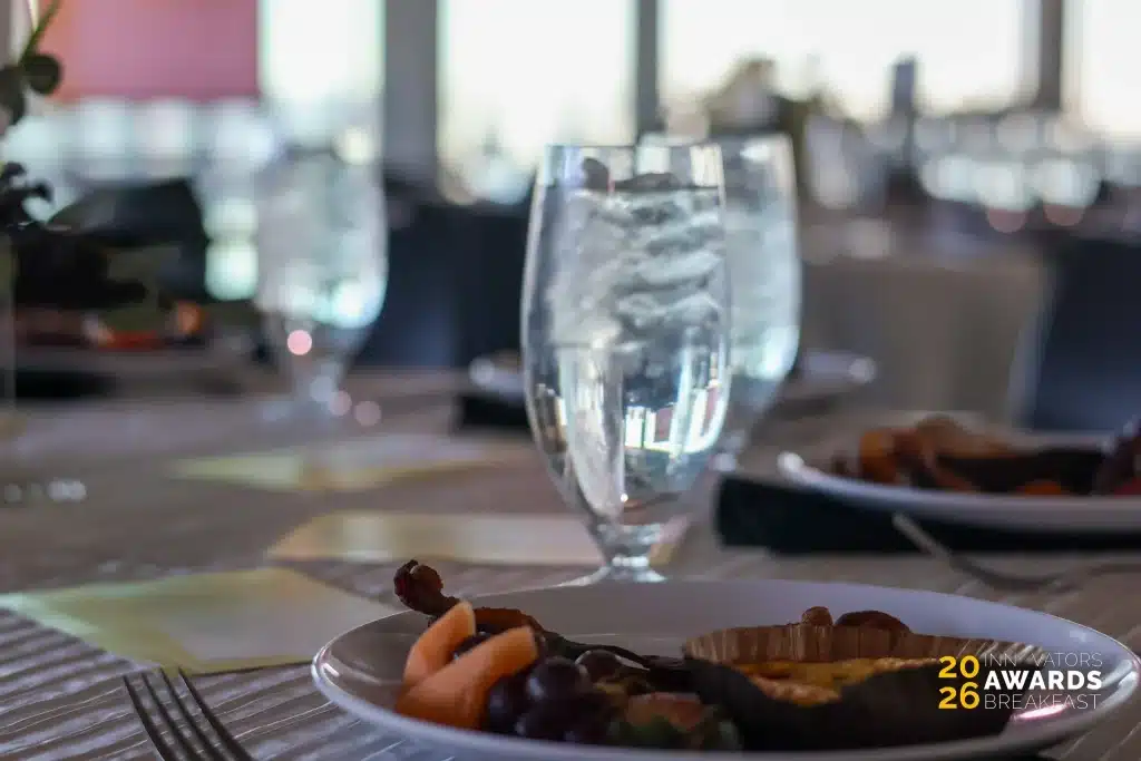 Breakfast plates and water glasses arranged on a table at the 2026 Innovators Awards Breakfast.