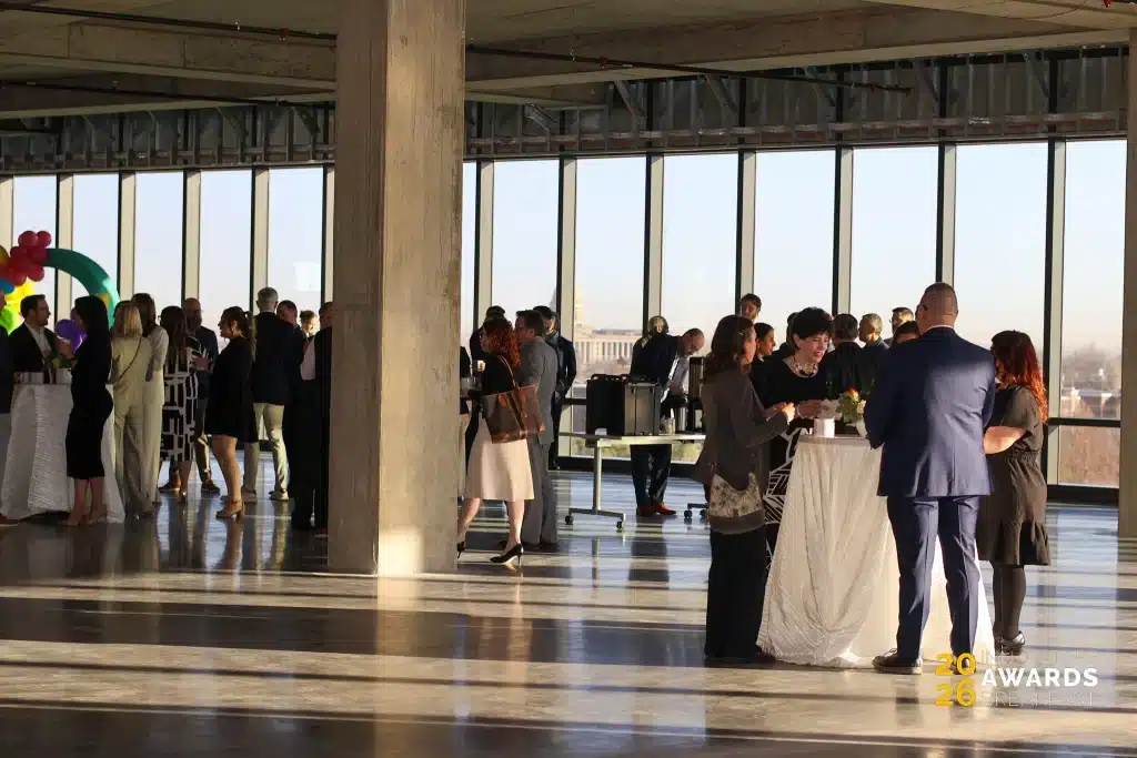 Guests mingle beside large windows before the Innovators Awards Breakfast.