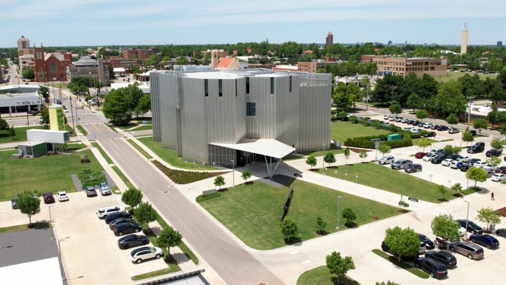 Oklahoma Contemporary arts center with its silver exterior and surrounding grounds.