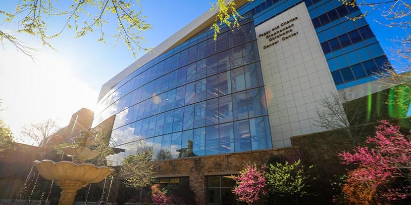 Exterior of the Stephenson Cancer Center with its glass façade and landscaped grounds.