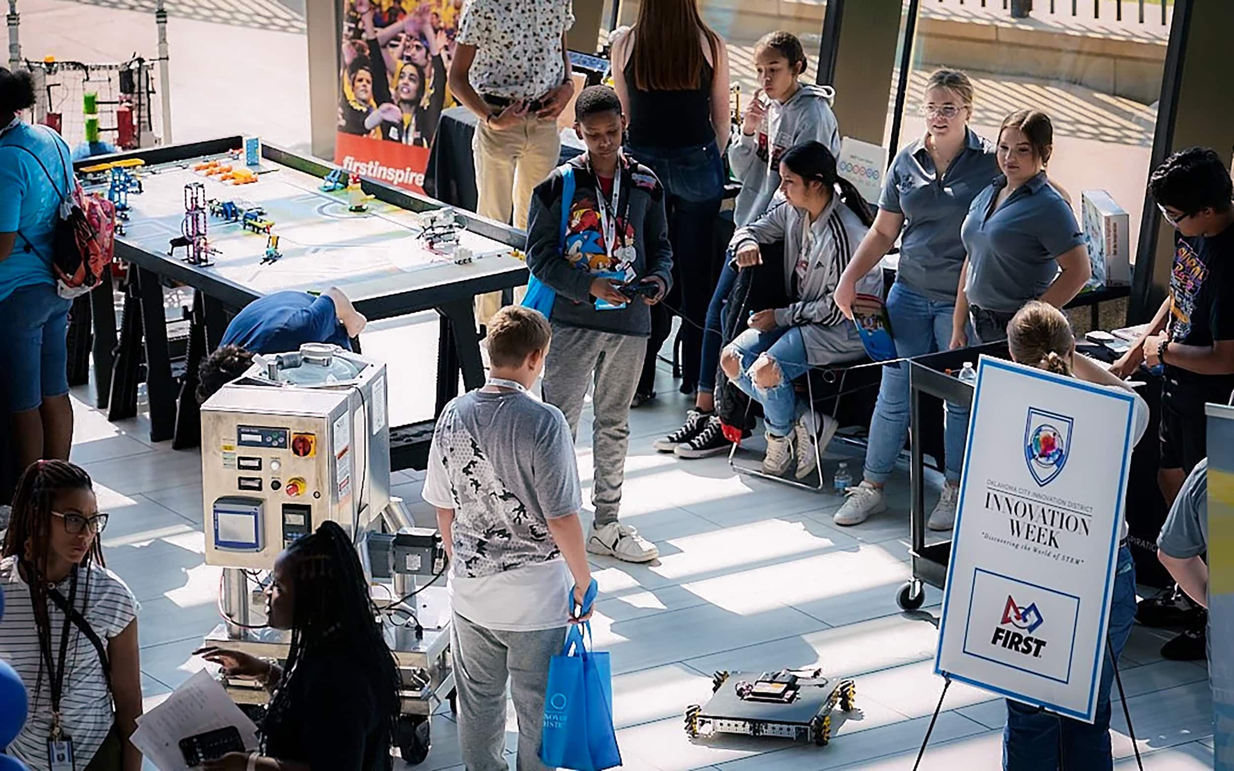 Students gather around a FIRST robotics demonstration during Innovation Week.