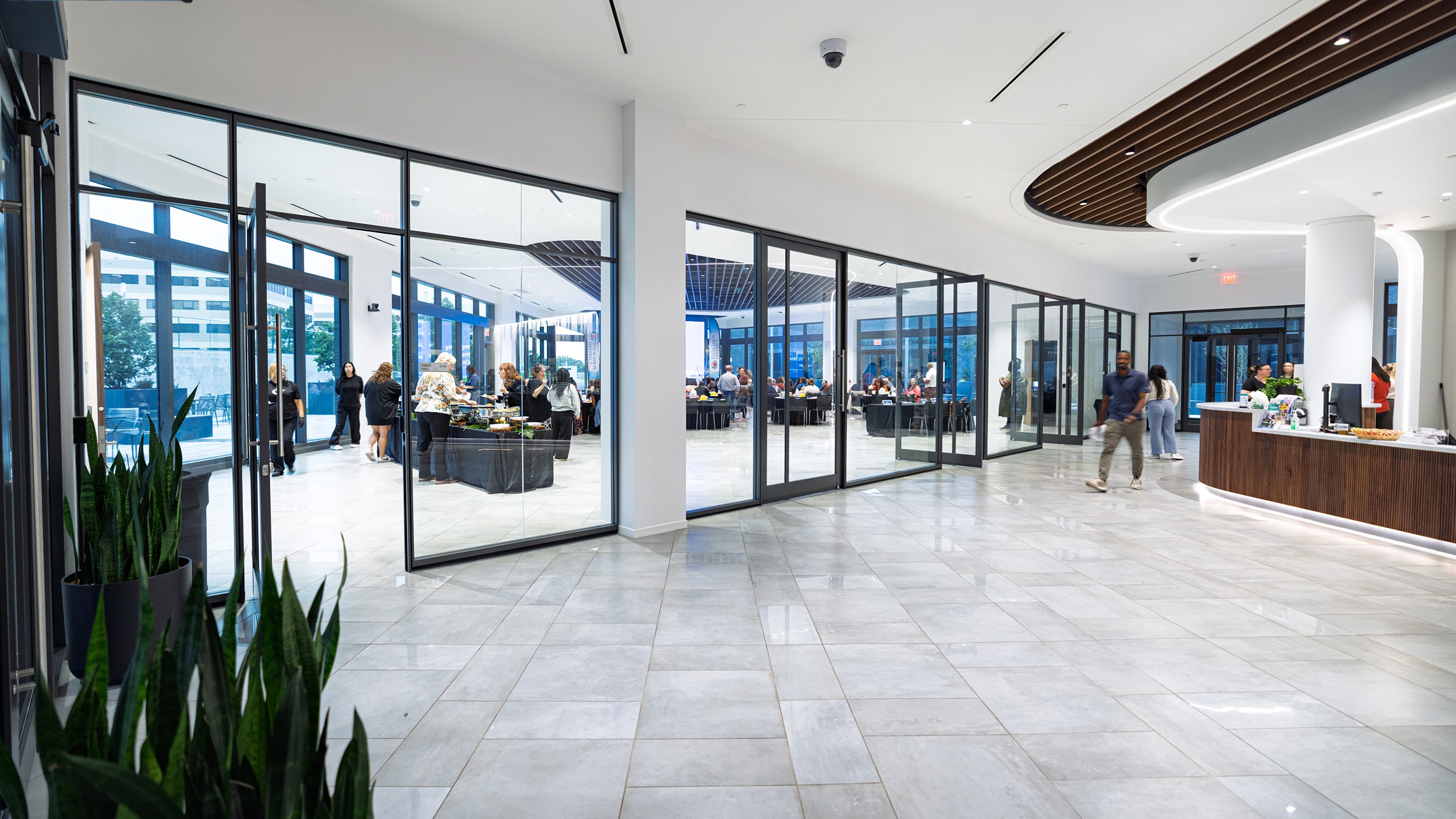 Innovation Hall lobby with glass-walled meeting spaces and a curved coffee counter.